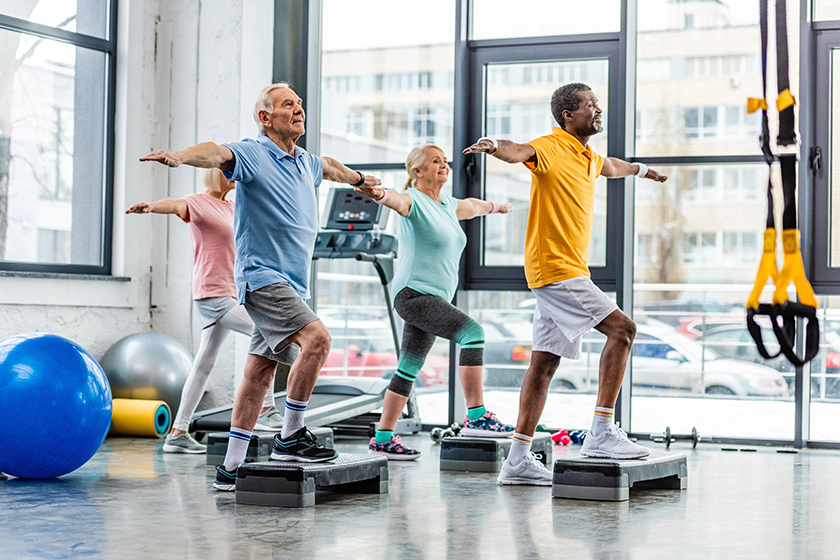 Multicultural senior sportspeople synchronous exercising 