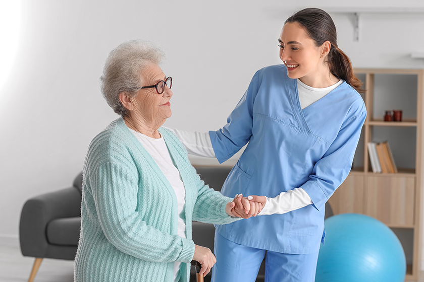 young-caregiver-helping-senior-woman-walking